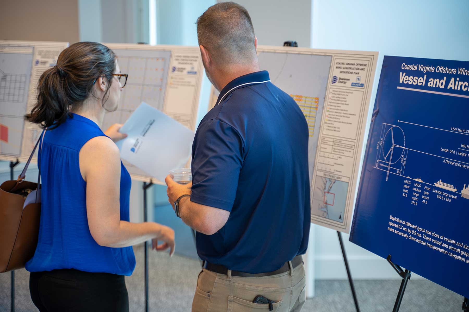 Dominion Energy employee explaining map to community member during open house